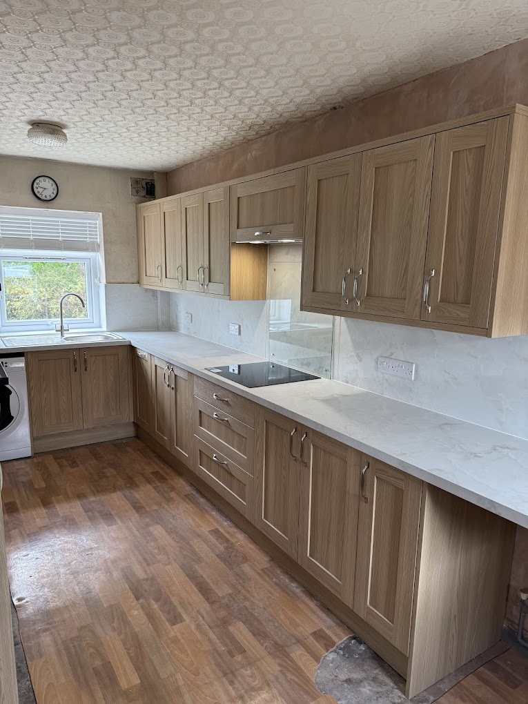 Oak fitted kitchen with stone worktops