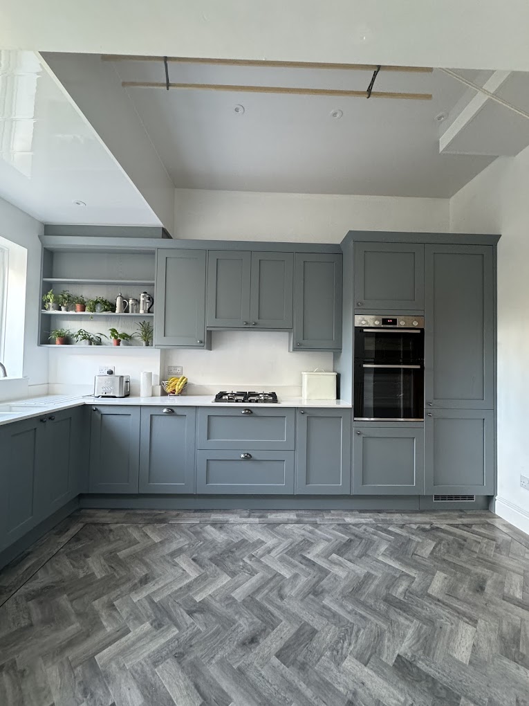 Blue-grey shaker kitchen with herringbone flooring