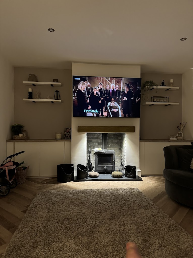 Living room with bespoke alcove shelving and media unit